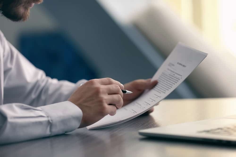 A man reading through a document.