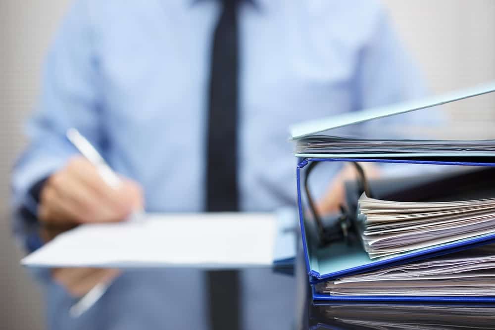 A man filing paperwork.